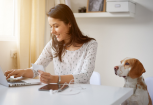 Woman working at home with a dog